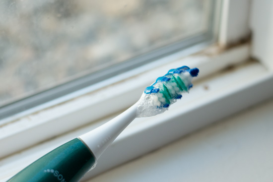 Use an electric toothbrush to clean window tracks