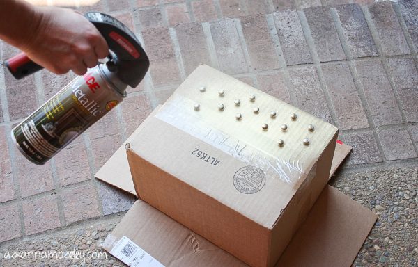 Spray painting tacks for a lampshade makeover