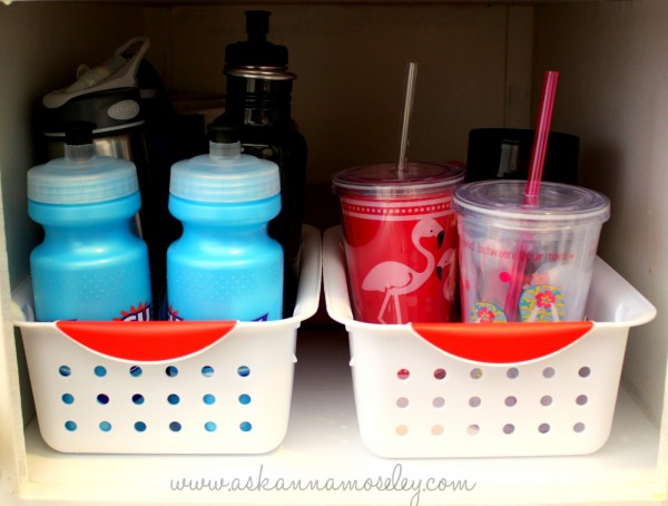 Organize water bottles with inexpensive baskets to keep them from falling over all the time - Ask Anna