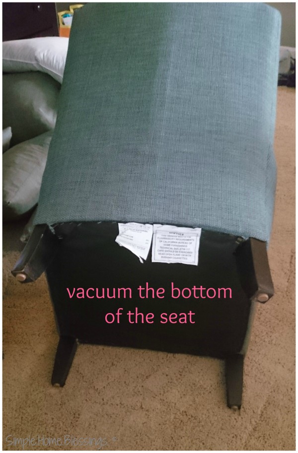 vacuum the bottom and back of the upholstered chair