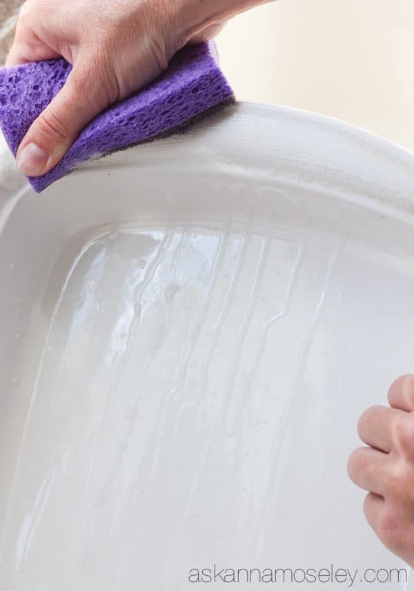 This is a really simple tip for how to clean baked-on grease off pots, pans & baking dishes. You will be AMAZED at how easy it is to get tough grease off with just a sponge and a little dish soap | Ask Anna