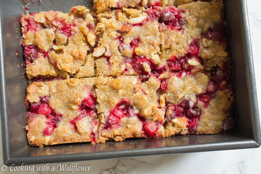 Sweet and tart fresh cranberries baked with a brown sugar butter crust on top. These cranberry crisp bars are so delicious and perfect for the holidays | Cooking With a Wallflower