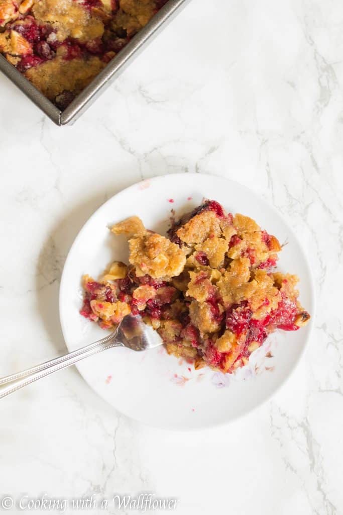 Sweet and tart fresh cranberries baked with a brown sugar butter crust on top. These cranberry crisp bars are so delicious and perfect for the holidays | Cooking With a Wallflower