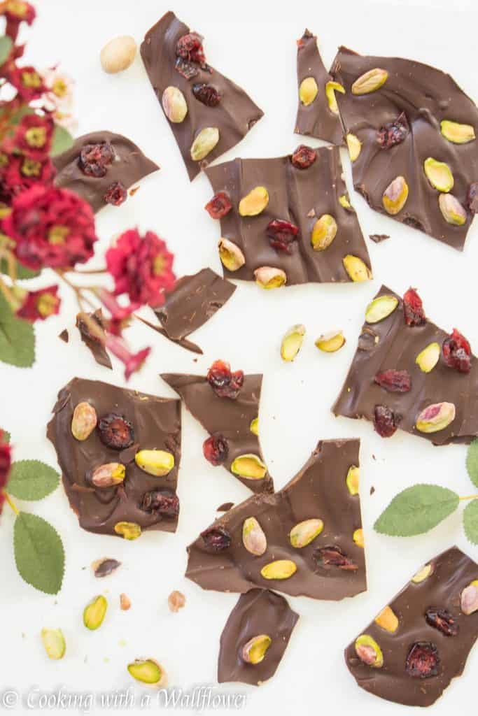 Semi sweet chocolate bark topped with sweet dried cranberries and salted pistachios. This cranberry pistachio chocolate bark is the perfect gift | Cooking With a Wallflower