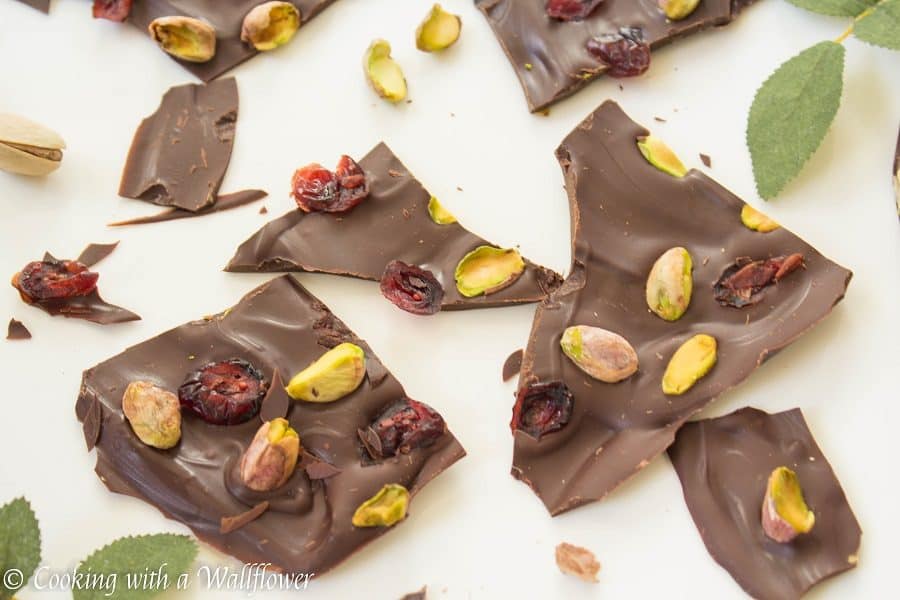 Semi sweet chocolate bark topped with sweet dried cranberries and salted pistachios. This cranberry pistachio chocolate bark is the perfect gift | Cooking With a Wallflower