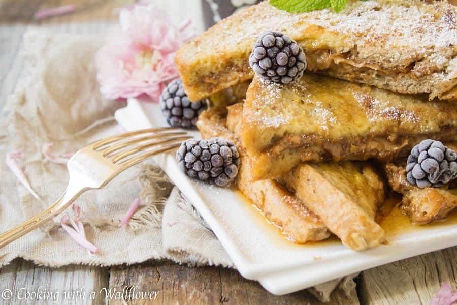 Thick crusty bread stuffed with cookie butter then dipped in a vanilla egg mixture. This cookie butter stuffed French toast is deliciously indulgent, perfect for brunch and special occasions like Mother's Day! | Cooking with a Wallflower