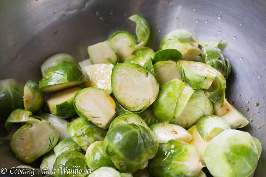 Brussels sprouts tossed in honey, sesame oil, and soy sauce then roasted until slightly charred. These roasted honey sesame brussels sprouts are delicious and a great side dish. | Cooking With a Wallflower