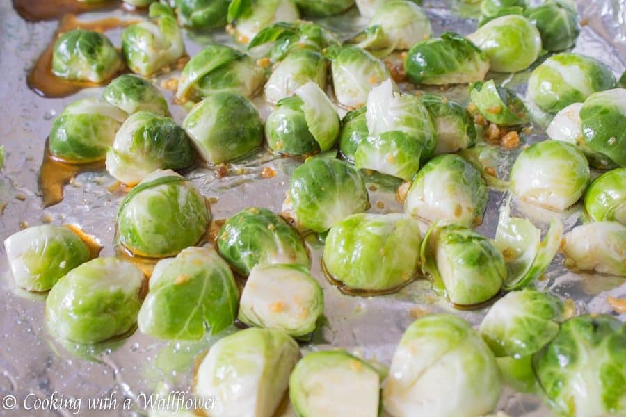 Brussels sprouts tossed in honey, sesame oil, and soy sauce then roasted until slightly charred. These roasted honey sesame brussels sprouts are delicious and a great side dish. | Cooking With a Wallflower