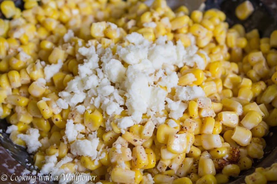 Corn kernels mixed with mayonnaise, melted butter, and queso fresco cheese then seasoned with chili powder and lime juice. This easy to make Mexican Street Corn is delicious and perfect as a side. | Cooking With a Wallflower