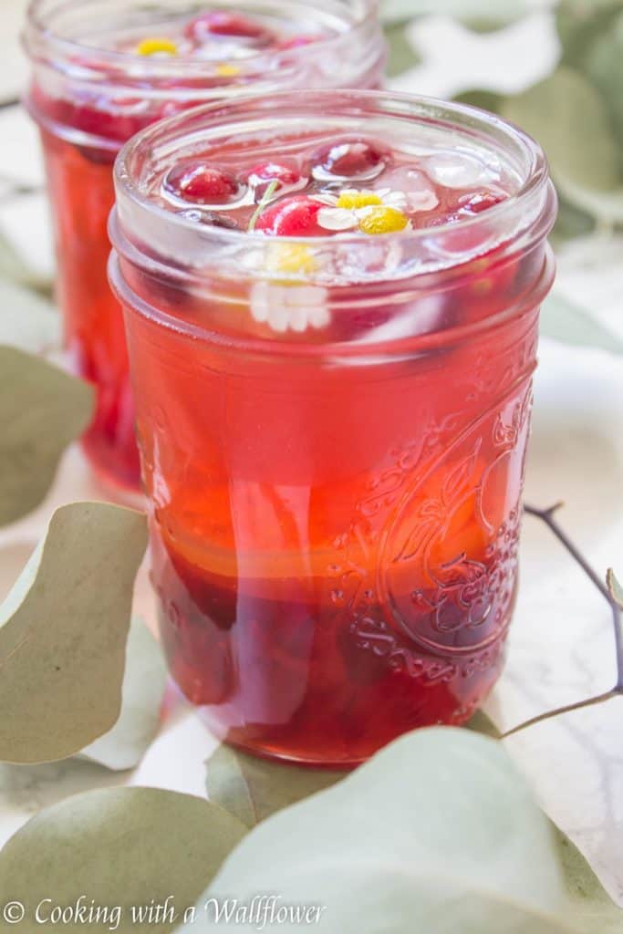 Hibiscus iced tea sweetened with cranberry simple syrup. This cranberry hibiscus iced tea delicious, refreshing and the perfect mocktail for the holidays. | Cooking with a Wildflower