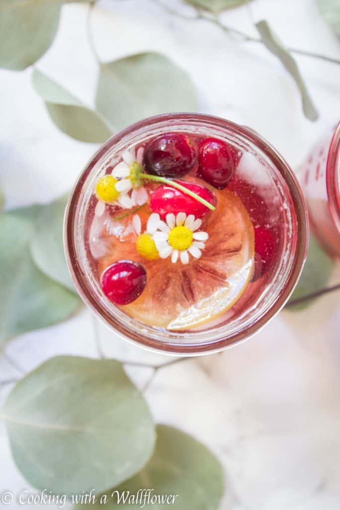 Hibiscus iced tea sweetened with cranberry simple syrup. This cranberry hibiscus iced tea delicious, refreshing and the perfect mocktail for the holidays. | Cooking with a Wildflower