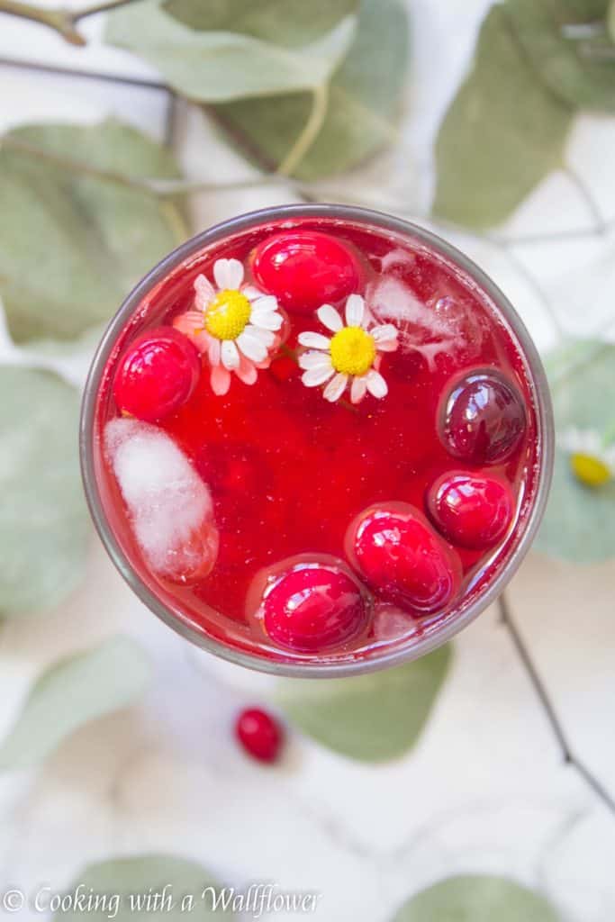 Hibiscus iced tea sweetened with cranberry simple syrup. This cranberry hibiscus iced tea delicious, refreshing and the perfect mocktail for the holidays. | Cooking with a Wildflower