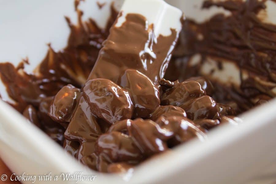 Roasted almonds coated with semi sweet chocolate then topped with a pinch of vanilla salt. These chocolate covered almond clusters are so simple to make and perfect for gifting. | Cooking With a Wallflower