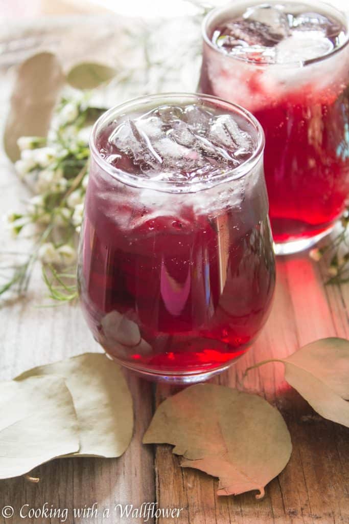 Pomegranate and hibiscus tea topped with vodka. This simple to make pomegranate hibiscus vodka iced tea is the perfect drink for a warm spring evening. | Cooking with a Wallflower