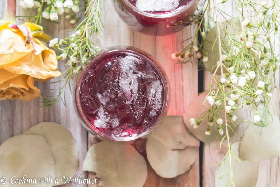 Pomegranate and hibiscus tea topped with vodka. This simple to make pomegranate hibiscus vodka iced tea is the perfect drink for a warm spring evening. | Cooking with a Wallflower