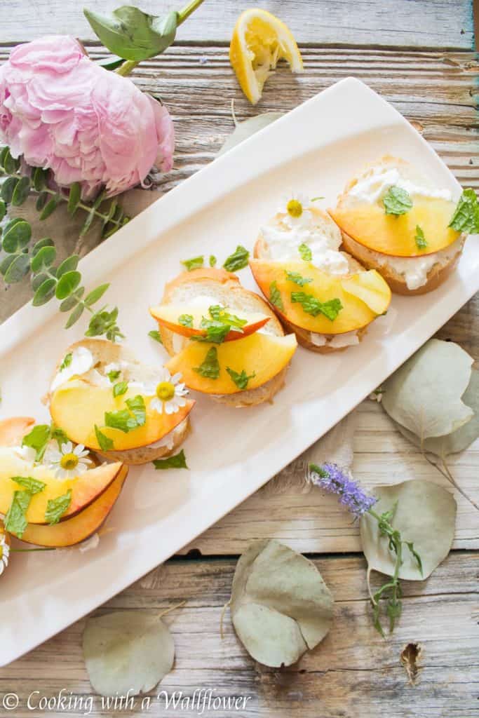 Crispy bread topped with fresh peaches, creamy burrata, mint and a sweet, tangy, honey, lemon dressing. Super fresh, easy to make, and pleasantly delicious, this peach burrata toast is the perfect appetizer for summer guests. | Cooking with a Wildflower