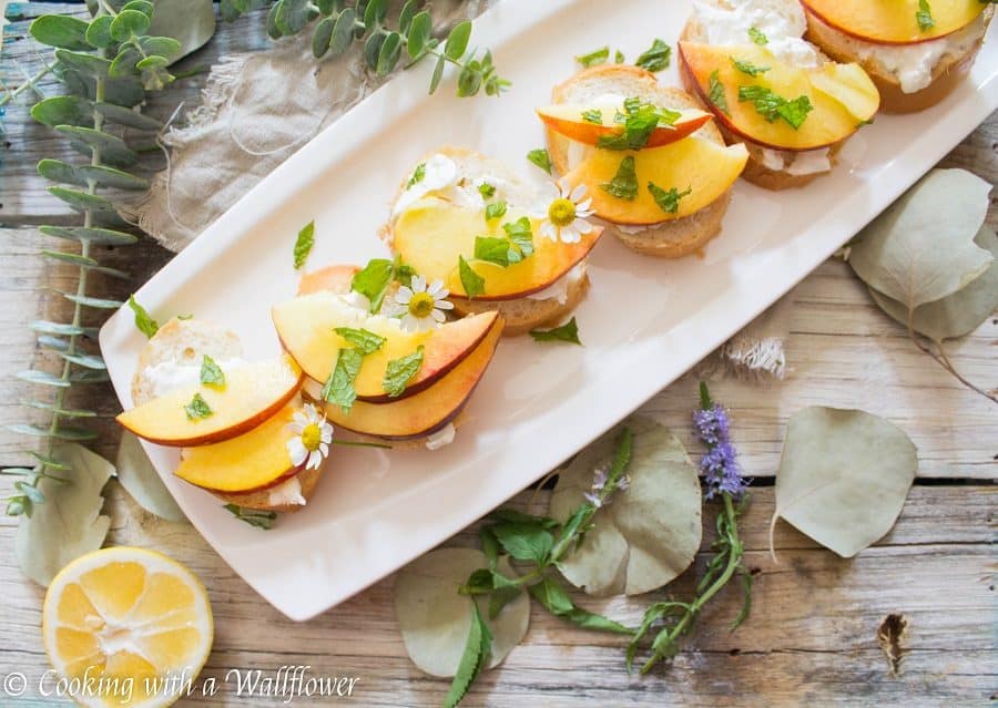 Crispy bread topped with fresh peaches, creamy burrata, mint and a sweet, tangy, honey, lemon dressing. Super fresh, easy to make, and pleasantly delicious, this peach burrata toast is the perfect appetizer for summer guests. | Cooking with a Wildflower