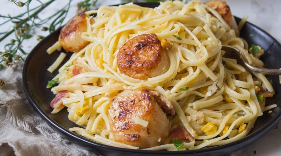 Pasta carbonara tossed with fresh corn and pan seared scallops is easier than it sounds! This Pasta Carbonara with Pan Seared Scallops is delicious and a great choice for a weeknight dinner. | Ask Anna