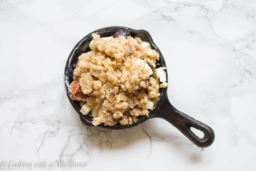 Caramelized figs topped with a buttery, crumble topping. This maple fig crumble is the perfect individually sized dessert for an early autumn dessert. | Cooking with a Wallflower