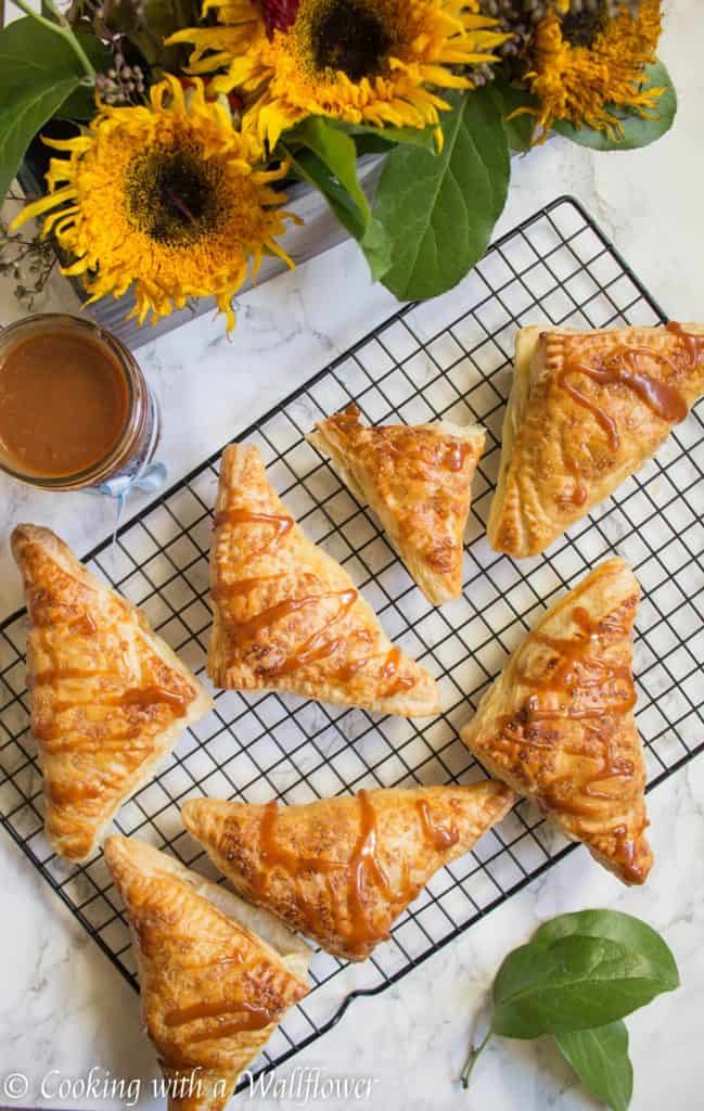 Puff pastries filled with cinnamon apples and drizzled with salted caramel, these salted caramel apple turnovers are simple to make and delicious. | Cooking with a Wallflower