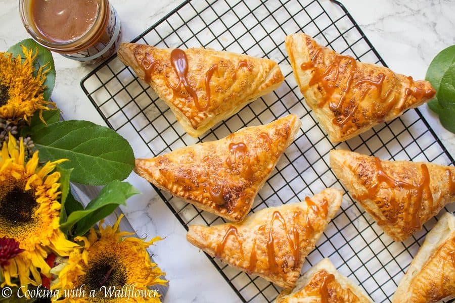 Puff pastries filled with cinnamon apples and drizzled with salted caramel, these salted caramel apple turnovers are simple to make and delicious. | Cooking with a Wallflower