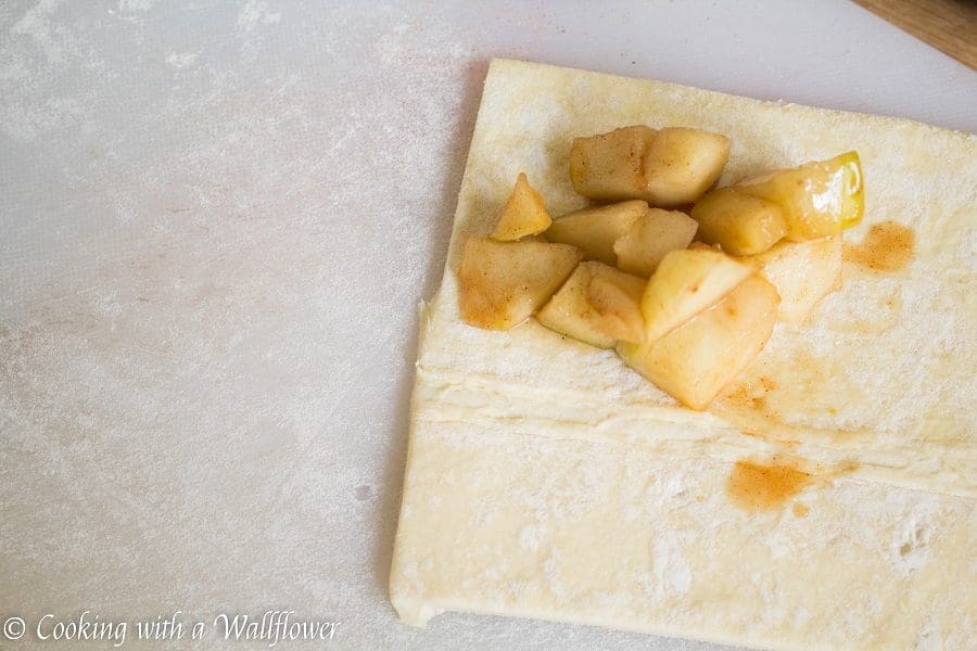 Puff pastries filled with cinnamon apples and drizzled with salted caramel, these salted caramel apple turnovers are simple to make and delicious. | Cooking with a Wallflower