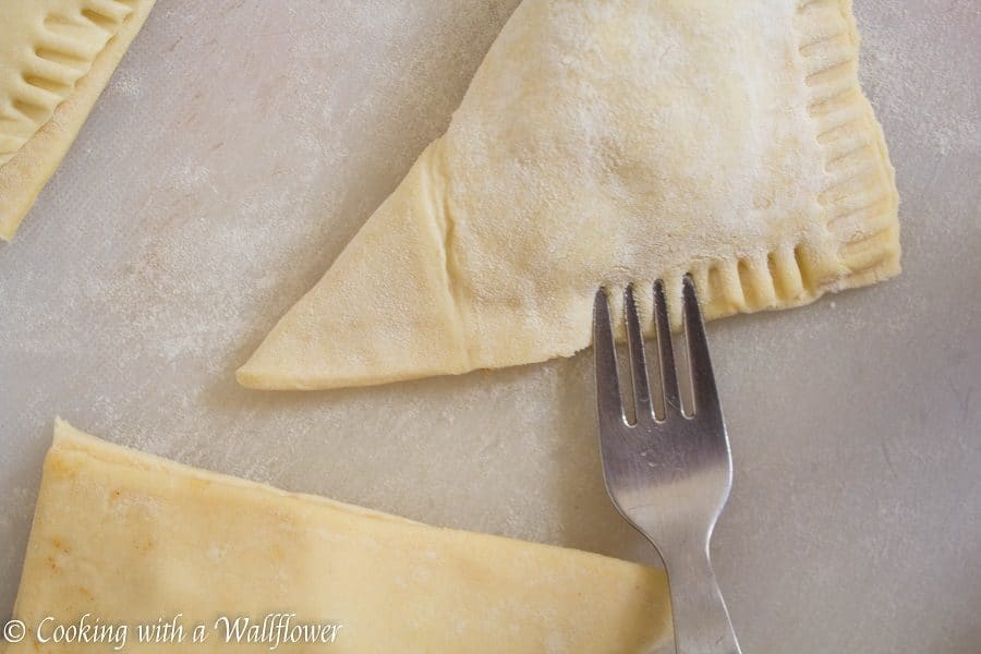 Puff pastries filled with cinnamon apples and drizzled with salted caramel, these salted caramel apple turnovers are simple to make and delicious. | Cooking with a Wallflower