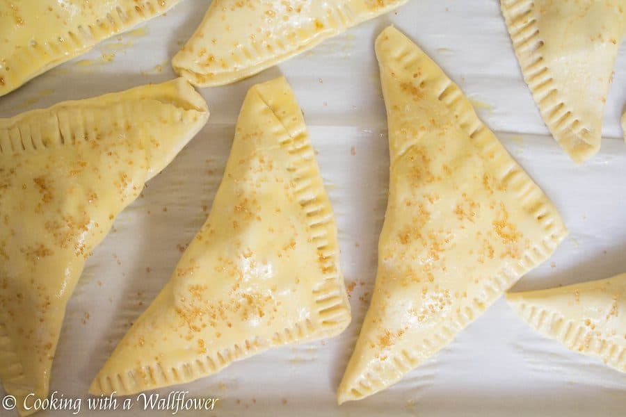 Puff pastries filled with cinnamon apples and drizzled with salted caramel, these salted caramel apple turnovers are simple to make and delicious. | Cooking with a Wallflower