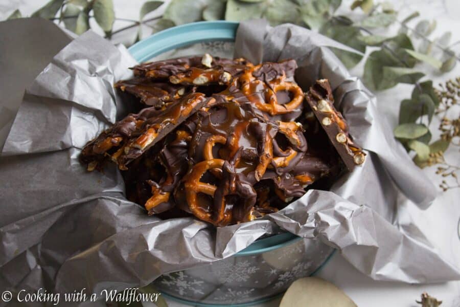 Semi sweet chocolate bark piled with mini pretzels and drizzled with salted caramel. This salted caramel pretzel bark is simple to make and the perfect sweet and savory snack. | Cooking with a Wallflower