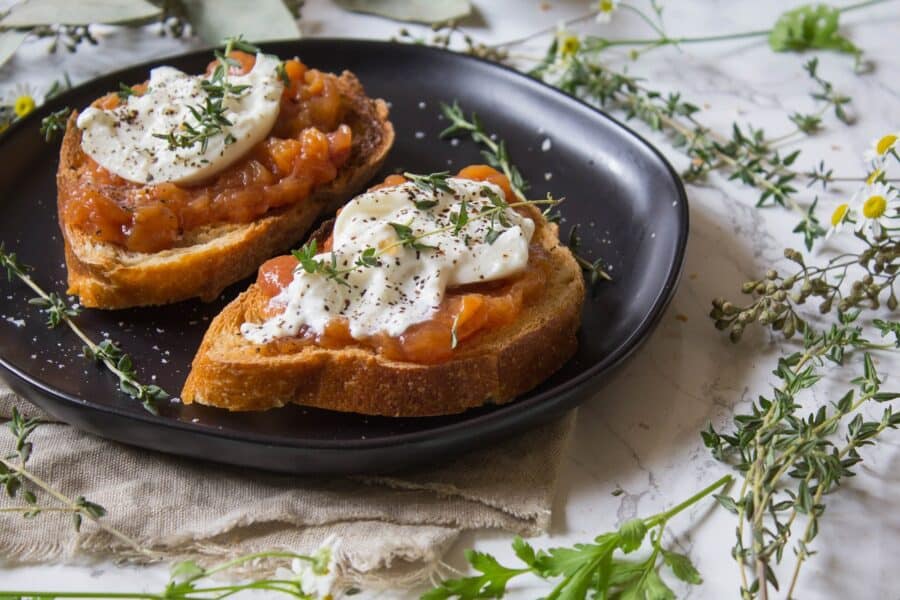 Toast topped with sweet peach jam, creamy burrata, thyme, salt and pepper. This Peach Jam Burrata Toast is delicious and perfect for breakfast or a late summer snack. | Cooking with a Wallflower