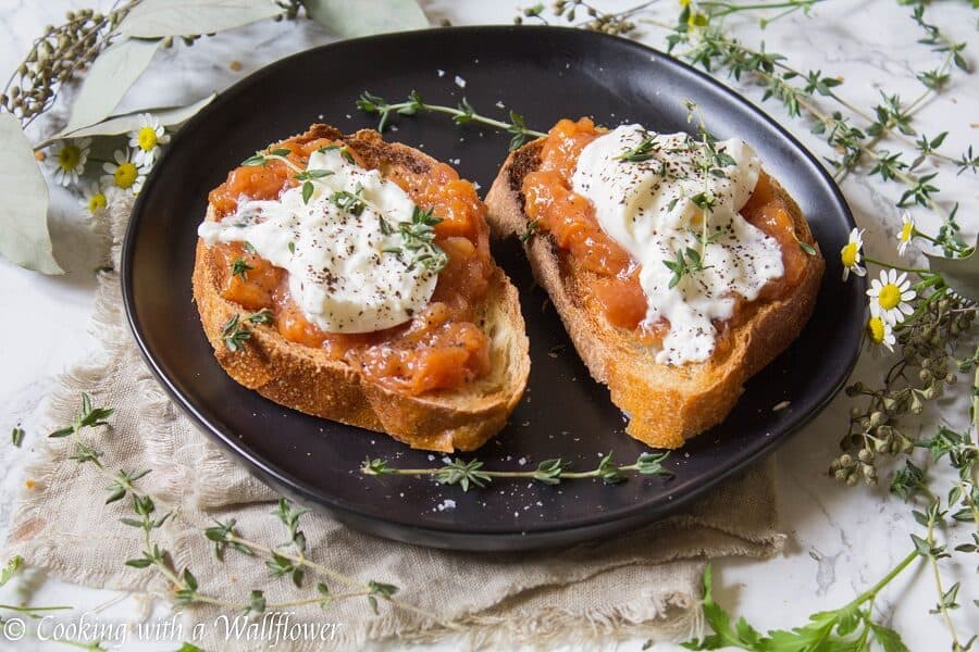 Toast topped with sweet peach jam, creamy burrata, thyme, salt and pepper. This Peach Jam Burrata Toast is delicious and perfect for breakfast or a late summer snack. | Cooking with a Wallflower