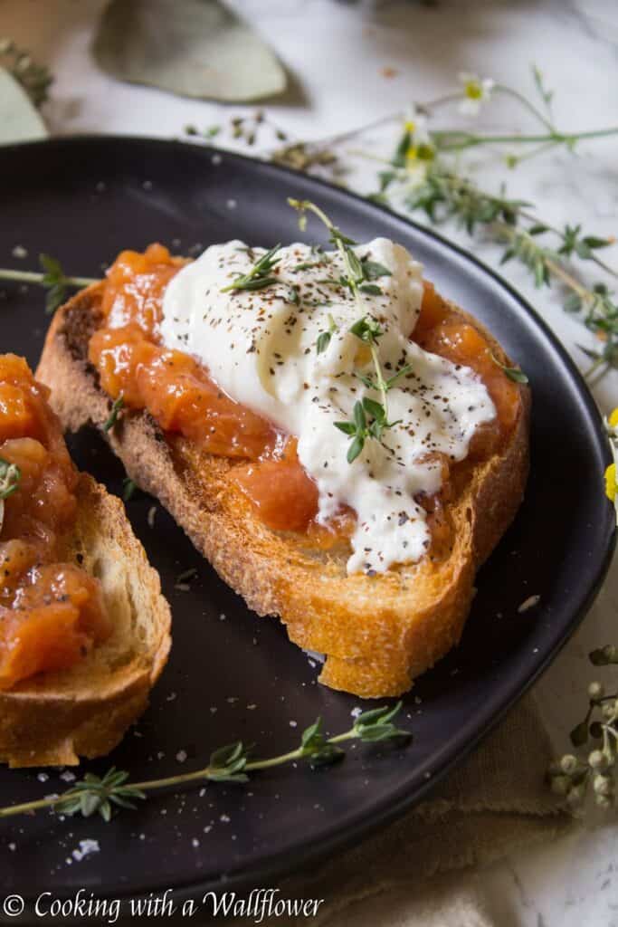 Toast topped with sweet peach jam, creamy burrata, thyme, salt and pepper. This Peach Jam Burrata Toast is delicious and perfect for breakfast or a late summer snack. | Cooking with a Wallflower