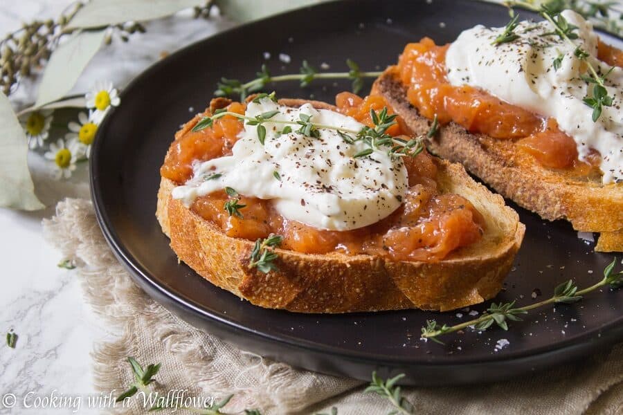 Toast topped with sweet peach jam, creamy burrata, thyme, salt and pepper. This Peach Jam Burrata Toast is delicious and perfect for breakfast or a late summer snack. | Cooking with a Wallflower