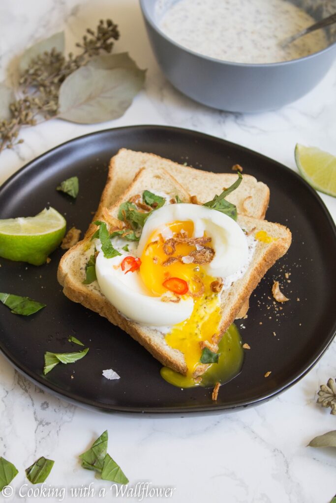 Toast with a garlic za’atar spread, topped with an egg and fresh herbs, this garlic egg toast is delicious, easy to make, and perfect for summer breakfast. | Ask Anna