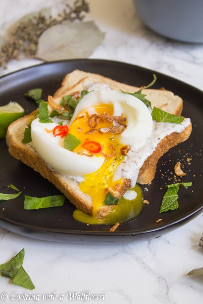 Toast with a garlic za’atar spread, topped with an egg and fresh herbs, this garlic egg toast is delicious, easy to make, and perfect for summer breakfast. | Ask Anna