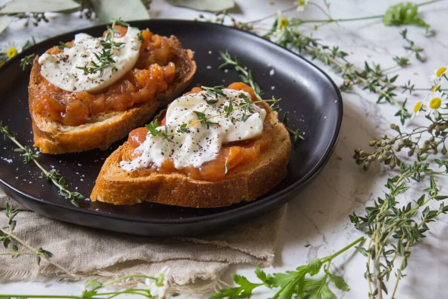 Toast topped with sweet peach jam, creamy burrata, thyme, salt and pepper. This Peach Jam Burrata Toast is delicious and perfect for breakfast or a late summer snack. | Ask Anna